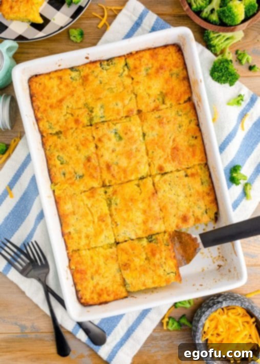 Homestyle Broccoli Cheddar Cornbread 17 A spatula getting a slice of Broccoli cheddar Cornbread out of the pan.