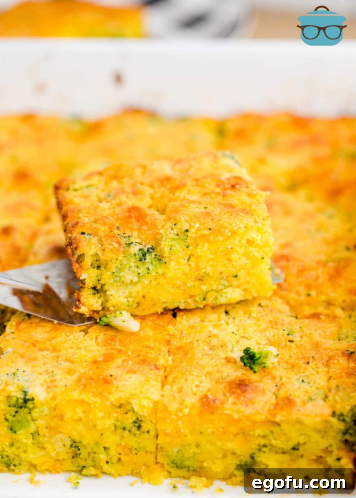 Homestyle Broccoli Cheddar Cornbread 9 A delicious slice of Broccoli Cheddar Cornbread resting on top of the golden pan of freshly baked cornbread.
