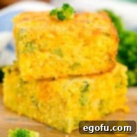 Homestyle Broccoli Cheddar Cornbread 10 A piece of Broccoli Cheddar Cornbread on top of another fresh made slice.