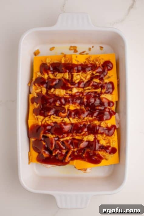 Zesty BBQ Chicken Sliders 13 BBQ sauce over fried onions, cheese, chicken, and bread.