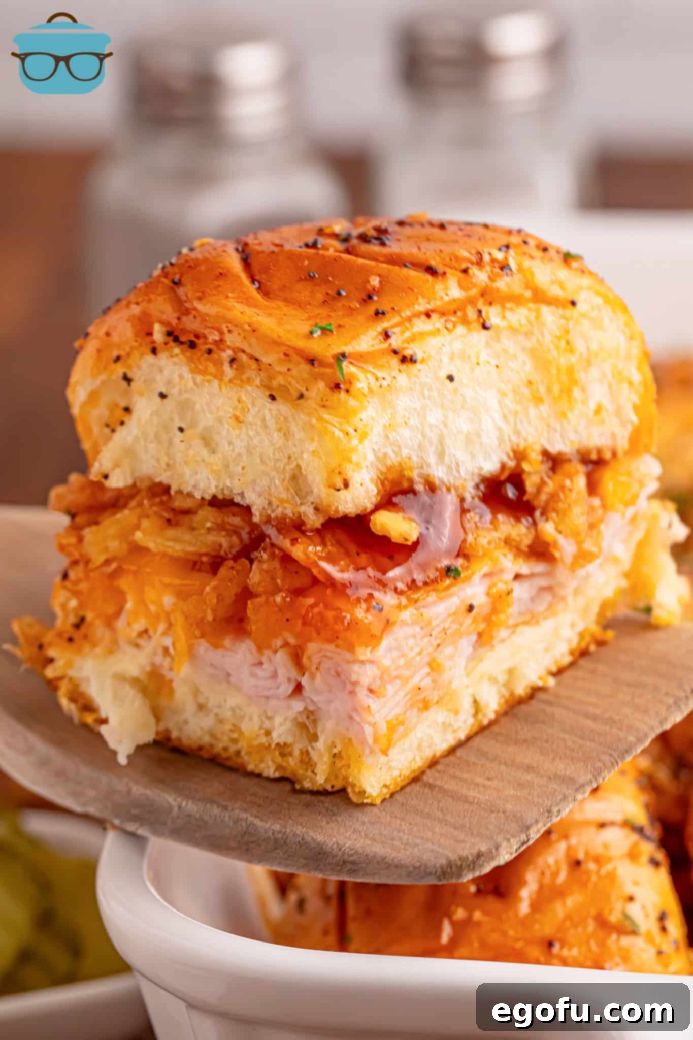 Zesty BBQ Chicken Sliders 8 Closely looking at a perfectly baked BBQ Chicken Slider on a wooden spatula, ready to be served.