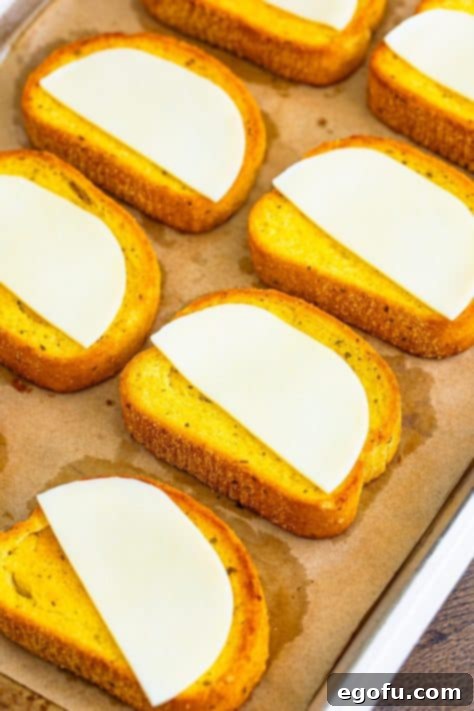 Provolone cheese halves placed on golden Texas Toast slices.