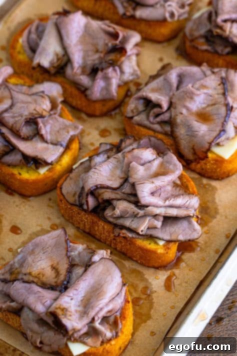 Roast beef slices layered on top of cheese on Texas Toast.
