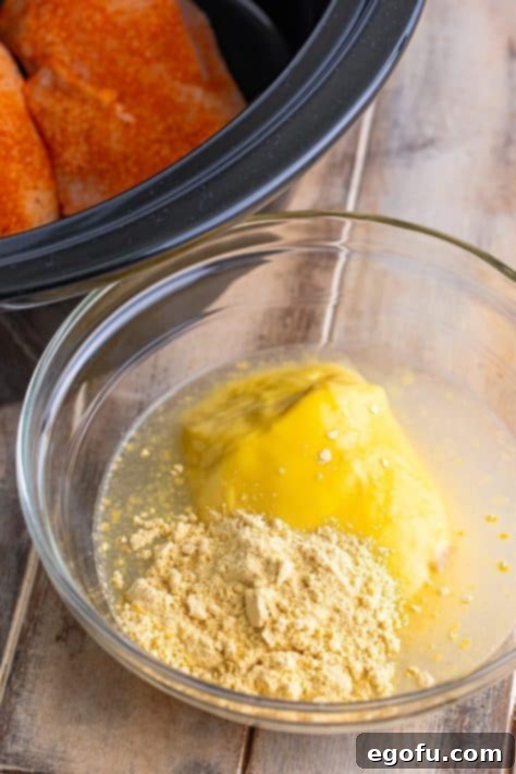 Date Night Slow Cooker Chicken and Gravy 12 A mixing bowl with chicken soup, water, and gravy mix.