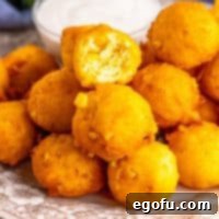 Sweet Corn Fritters 9 Close up looking at a small pile of golden-brown Sweet Corn Fritters.