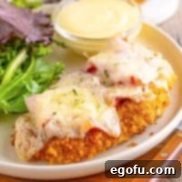 California Stuffed Chicken 13 A few pieces of Malibu Chicken on a plate with sides.