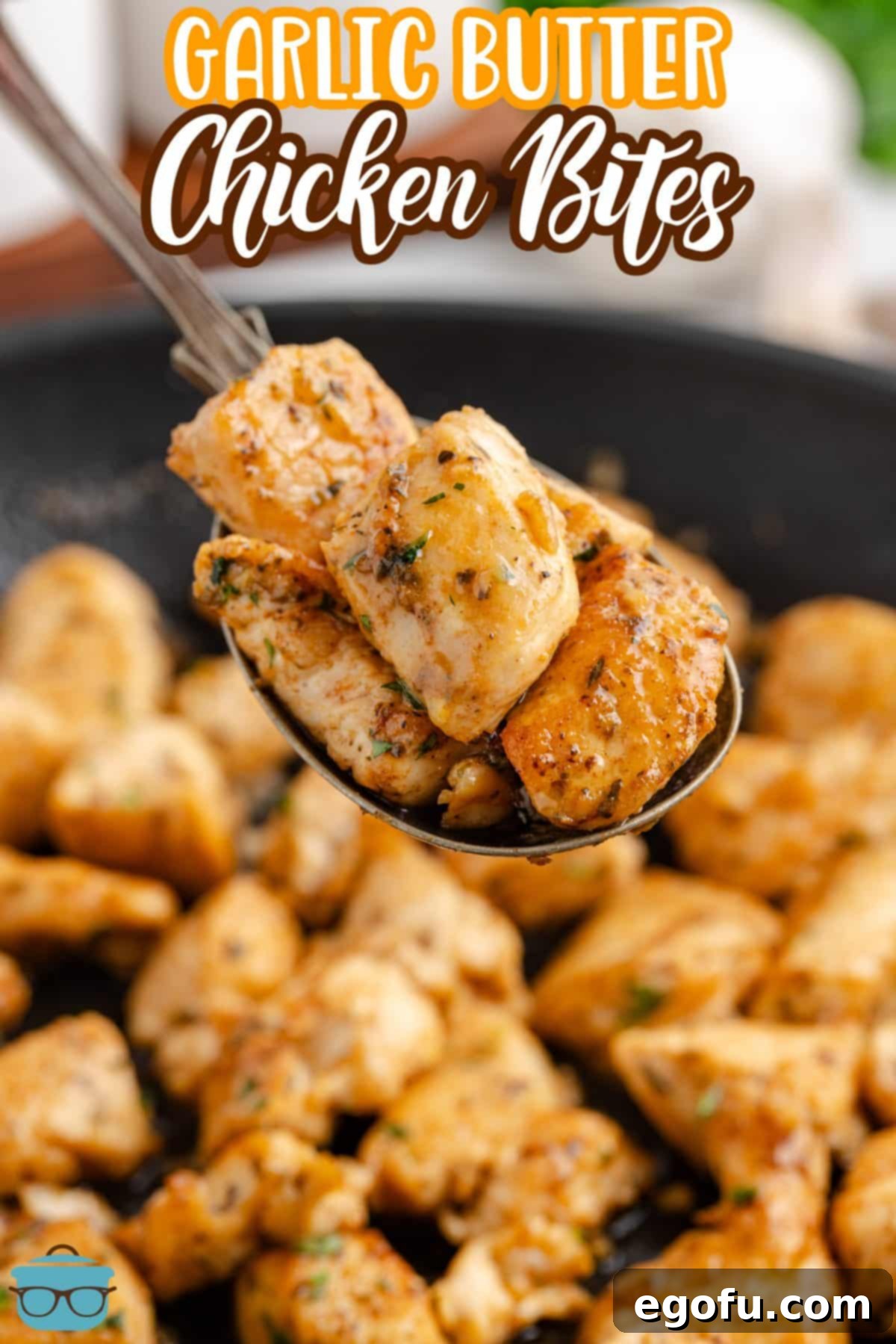 A scoop of Garlic Butter Chicken Bites above the skillet.