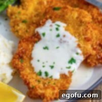 Close-up of a plated Cheesecake Factory Chicken Costoletta with sauce, ready to be eaten.