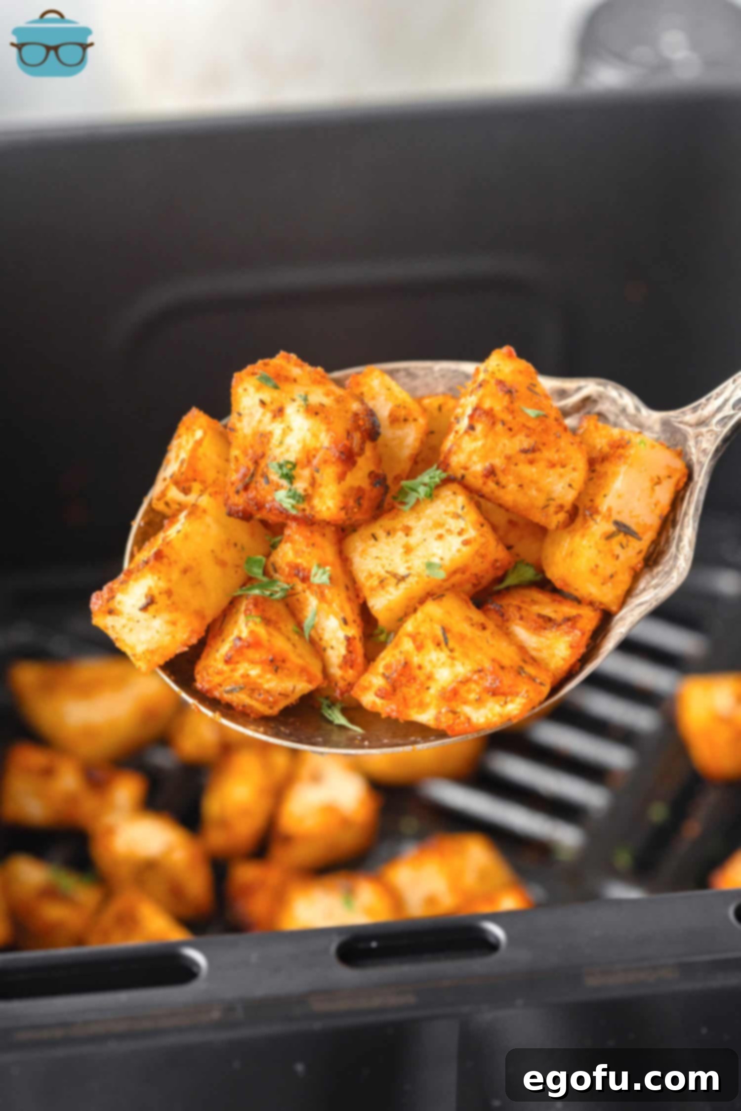 Crispy Air Fryer Breakfast Potatoes 2 A spoonful of golden brown and crispy Air Fryer Home Fries, freshly cooked.