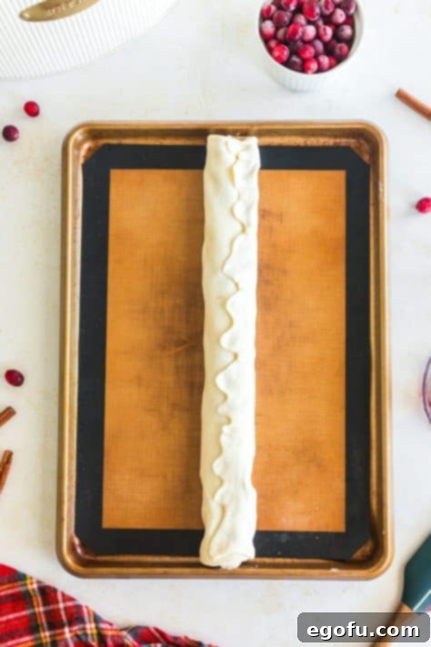 Rolled up puff pastry with cranberry and sweetened cream cheese filling.