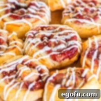 Closer look at a few homemade Cranberry Pinwheels, showcasing their texture and icing.