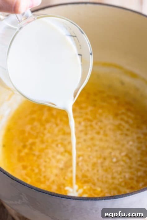 Heavy cream being added to a pot.