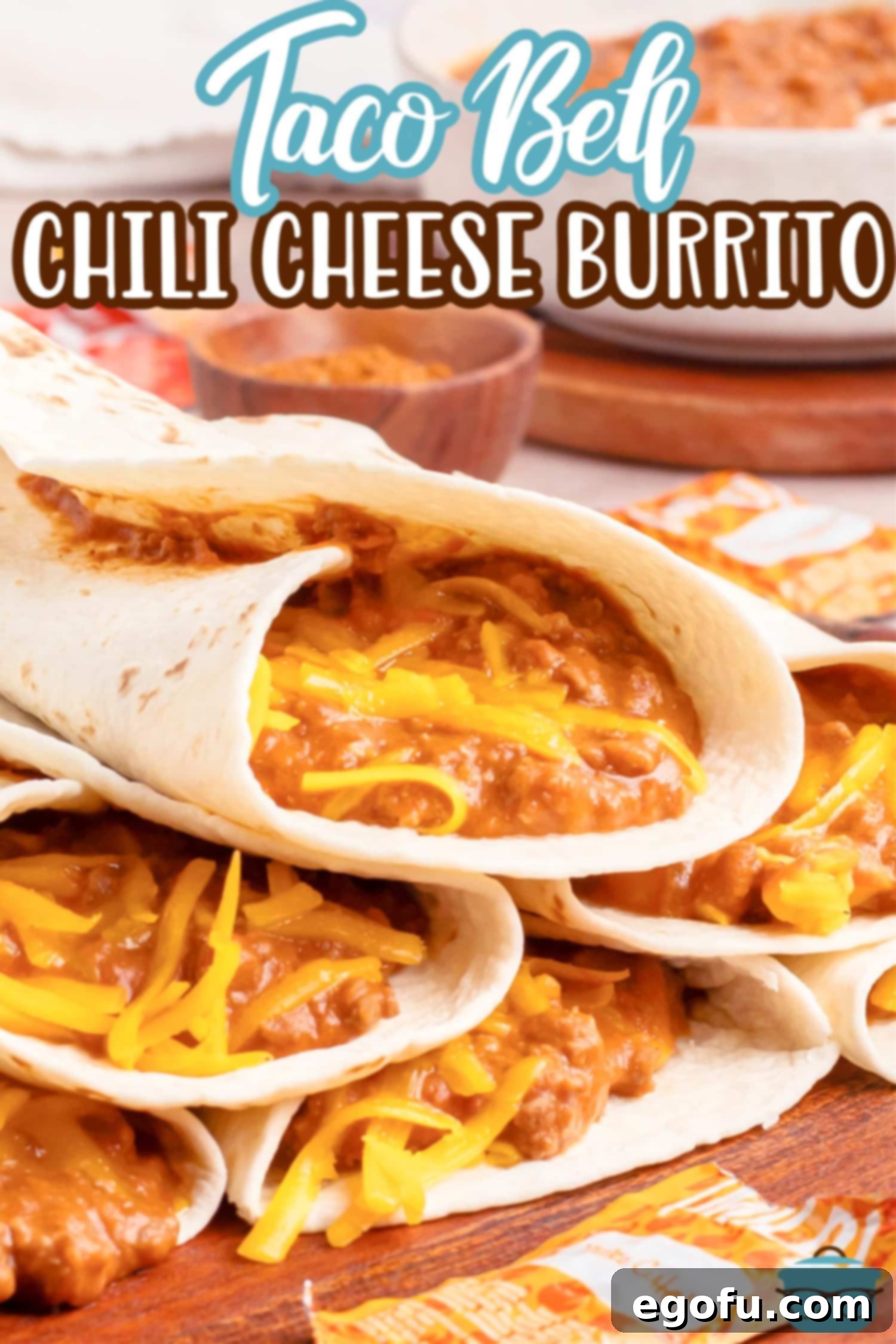 A cutting board showcasing several delicious copycat Taco Bell Chili Cheese Burritos, some cut in half to reveal the cheesy, meaty filling.