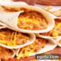 A small pile of perfectly wrapped, warm homemade Taco Bell Chili Cheese Burritos.