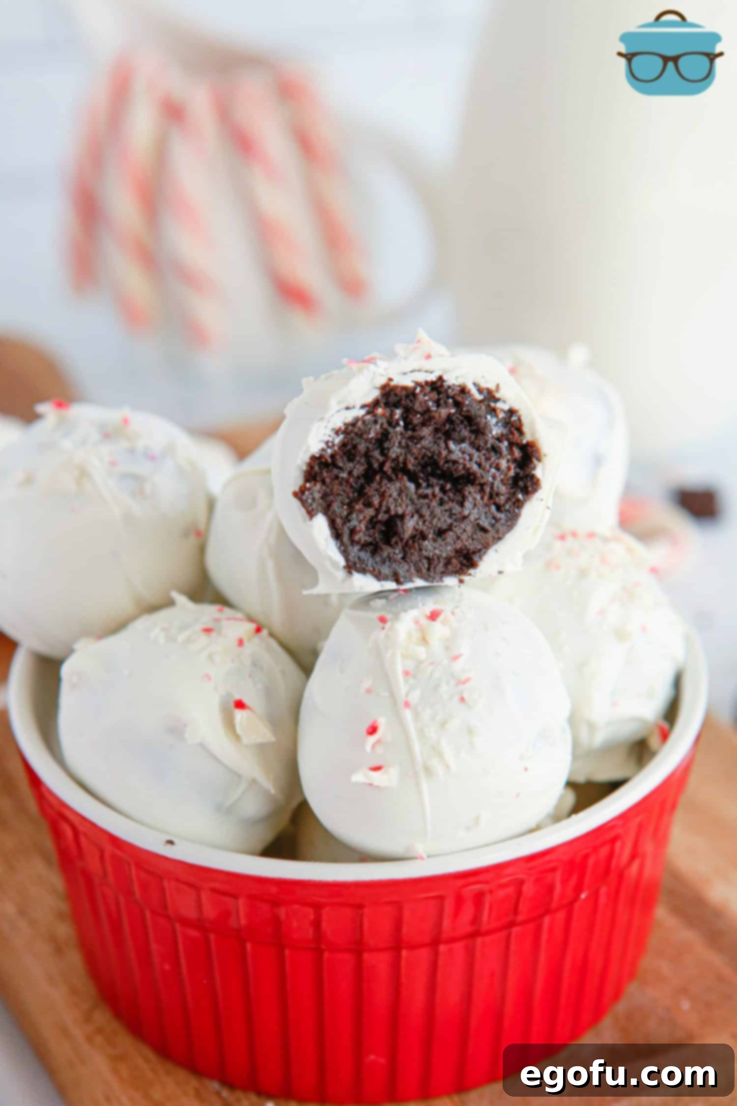 A small bowl of Peppermint Oreo Balls with one missing a bite.