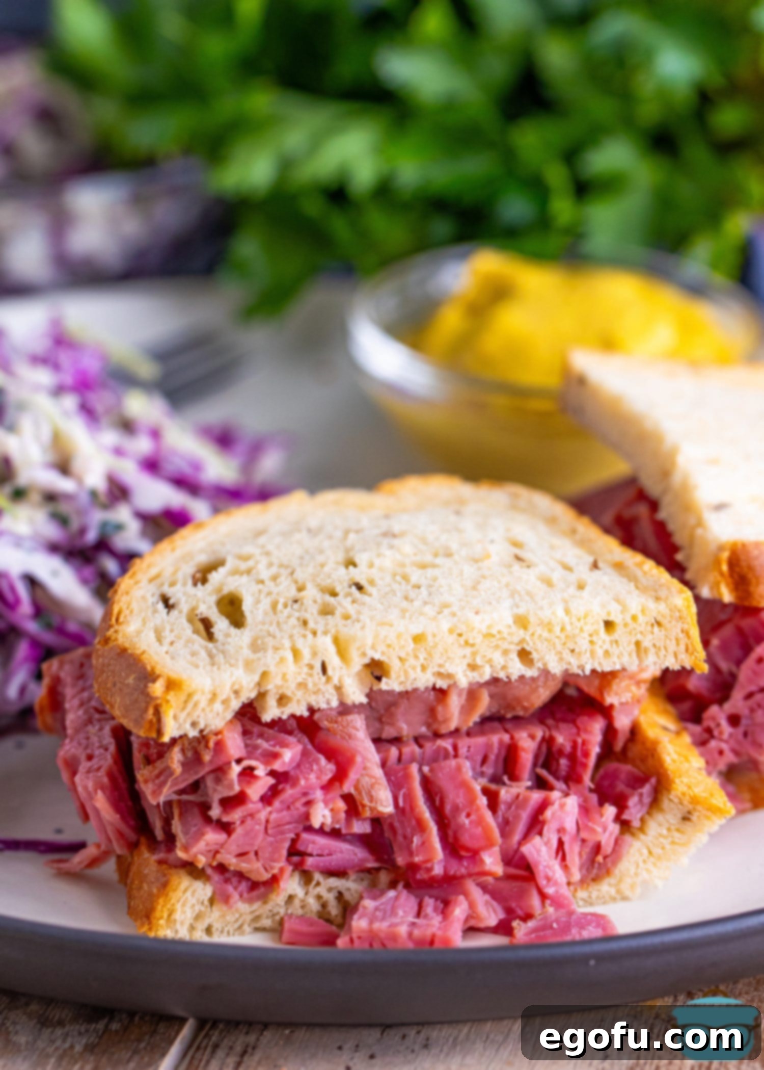 Set-It-and-Forget-It Corned Beef 2 A delectable corned beef sandwich served on a plate with accompanying sides, showcasing the versatility of this slow-cooked dish.