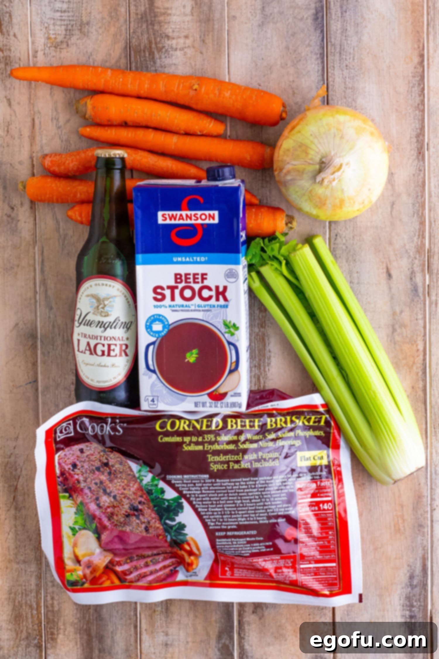 Set-It-and-Forget-It Corned Beef 4 A visual representation of the six simple ingredients required for Slow Cooker Corned Beef: celery, carrots, onion, corned beef brisket, beef stock, and a lager beer.