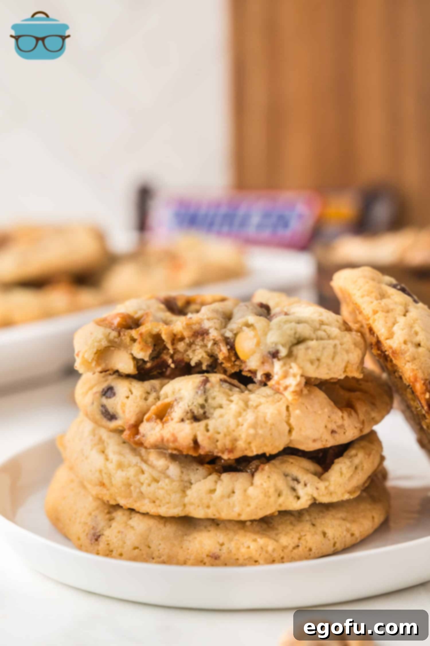 A small dessert plate of Snickers Cookies, showcasing their chewy texture and generous inclusions.