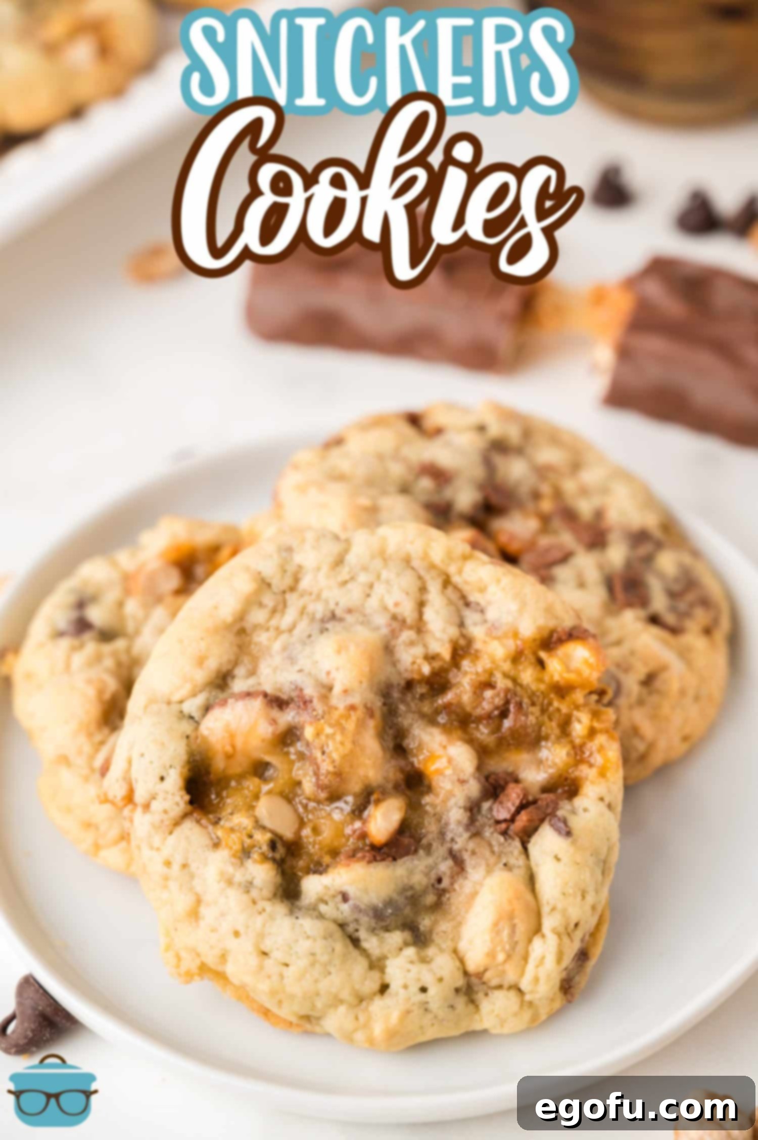 A few Snickers Cookies neatly arranged on a plate, showcasing their inviting golden-brown edges.