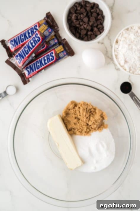 A bowl with butter, granulated sugar and light brown sugar.