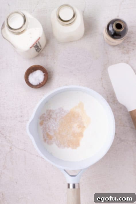 A bowl with heavy cream, whole milk, vanilla and a pinch of salt.