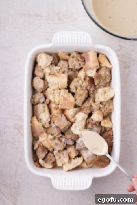 Banana bread pudding mixture carefully placed into a baking dish, ready for baking.