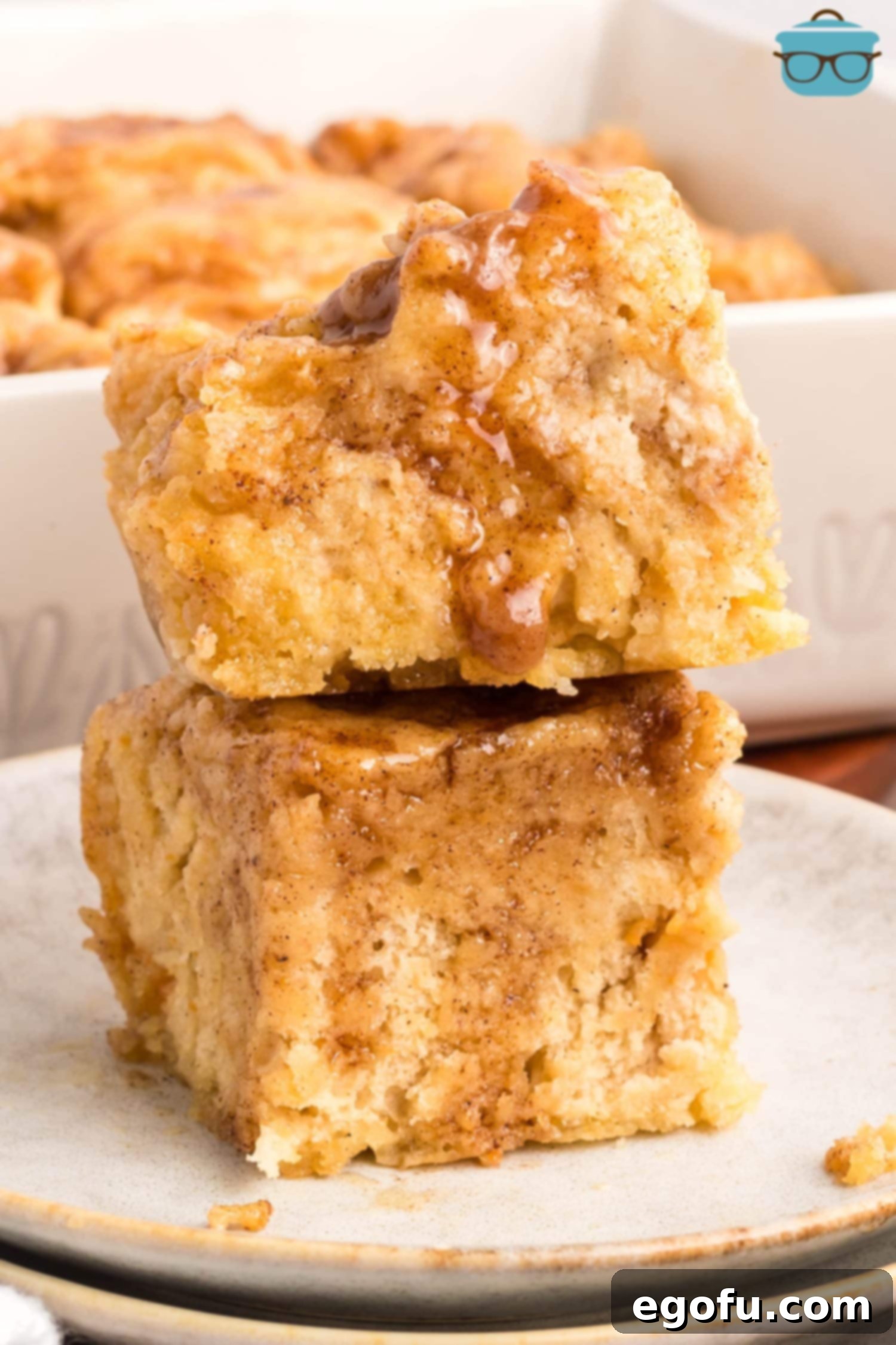 Two stacked Sweet Potato Butter Swim Biscuits, showing their tender interior and glistening glaze.