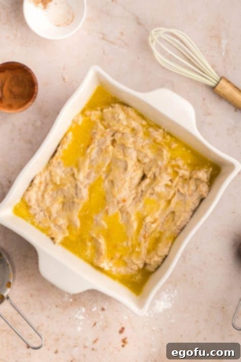 Biscuit dough in melted butter in a baking dish.