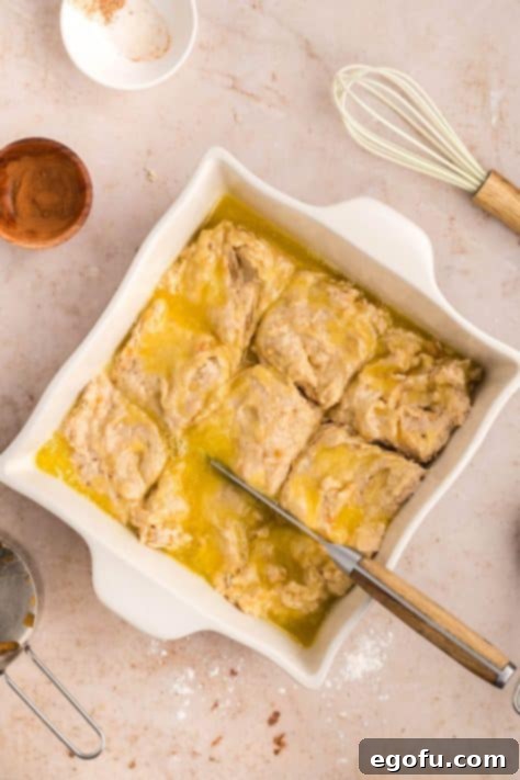 Dough cut into 9 squares in a dish.