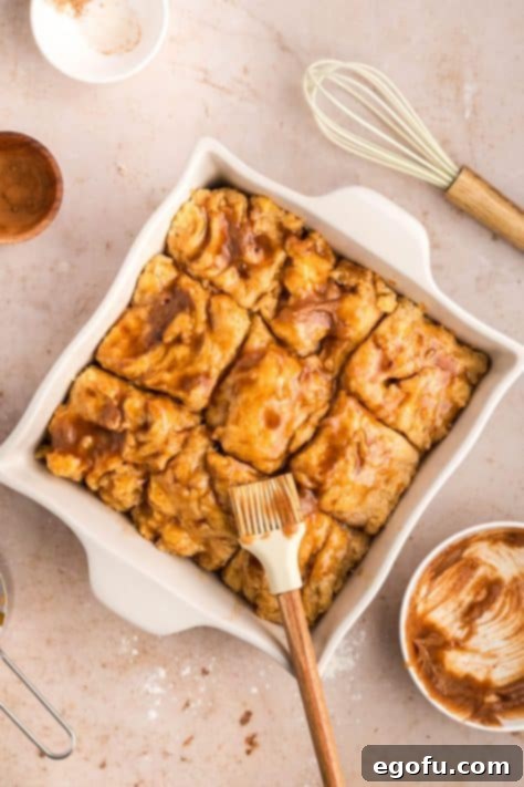 A brush brushing the sweet glaze on top.
