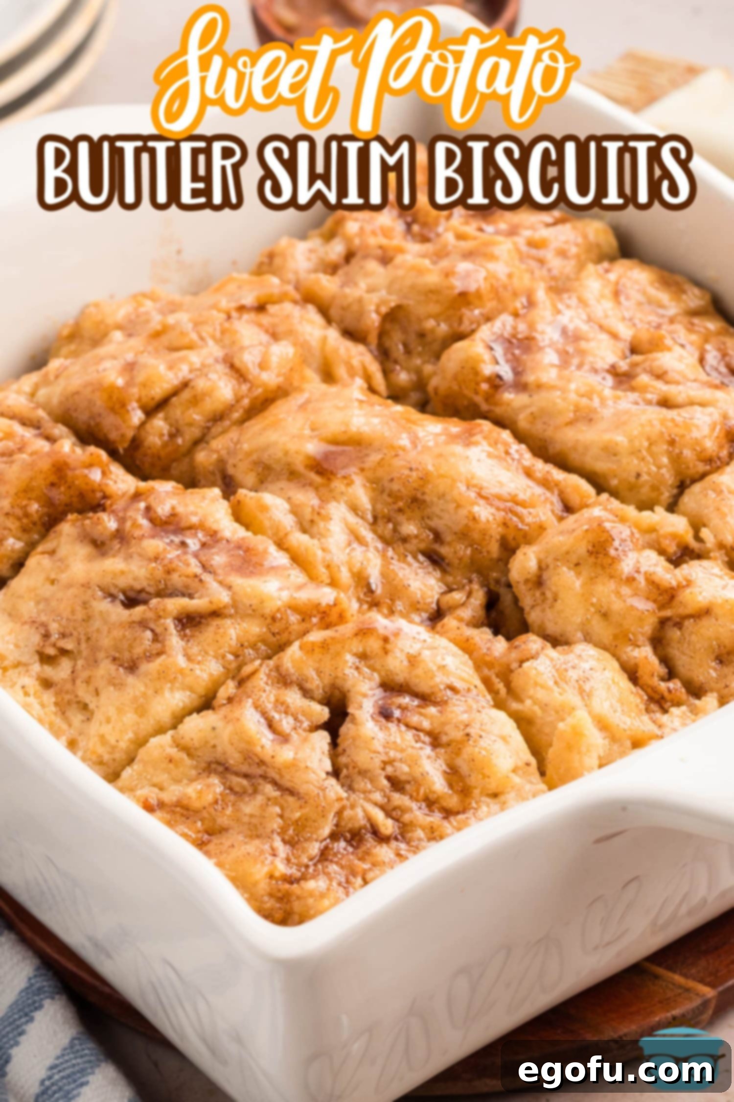 A baking dish filled with Sweet Potato Butter Swim Biscuits, pre-cut into squares and ready to bake.