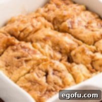 Looking closely at a perfectly baked Sweet Potato Butter Swim Biscuit, showing its texture and glaze.
