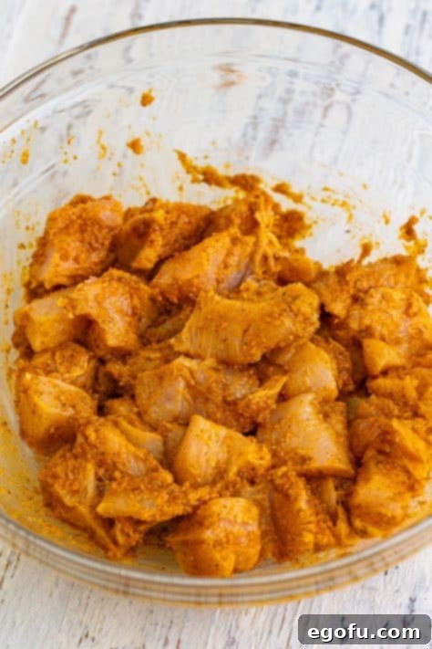 Chicken pieces being coated in marinade.