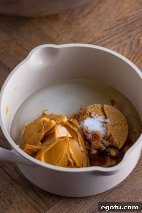 Crispy Peanut Butter Dream Bars 17 A pot with corn syrup, peanut butter, brown sugar, granulated sugar, and salt.