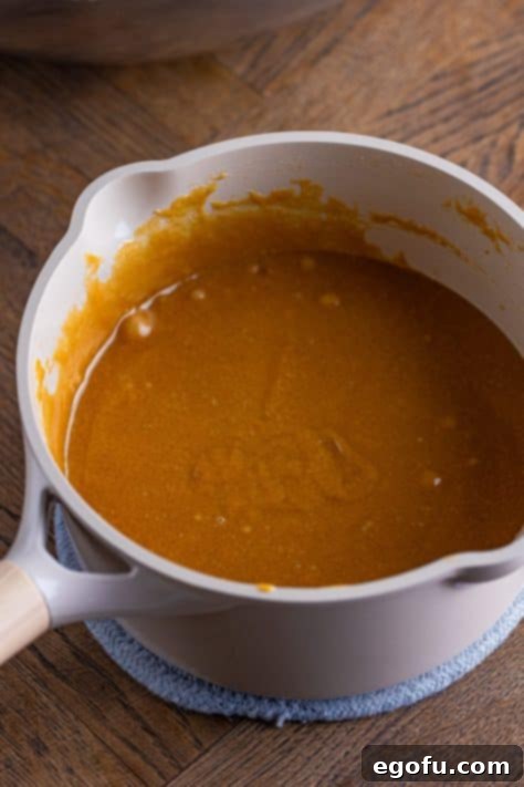 Crispy Peanut Butter Dream Bars 18 A pot with melted corn syrup, peanut butter, brown sugar, granulated sugar, and salt all together.