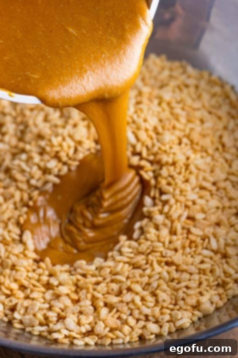 Crispy Peanut Butter Dream Bars 20 Sweet mixture being added to crispy rice cereal.
