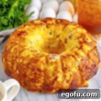 A top-down view of a beautifully golden, uncut Breakfast Bundt Cake, ready for slicing.