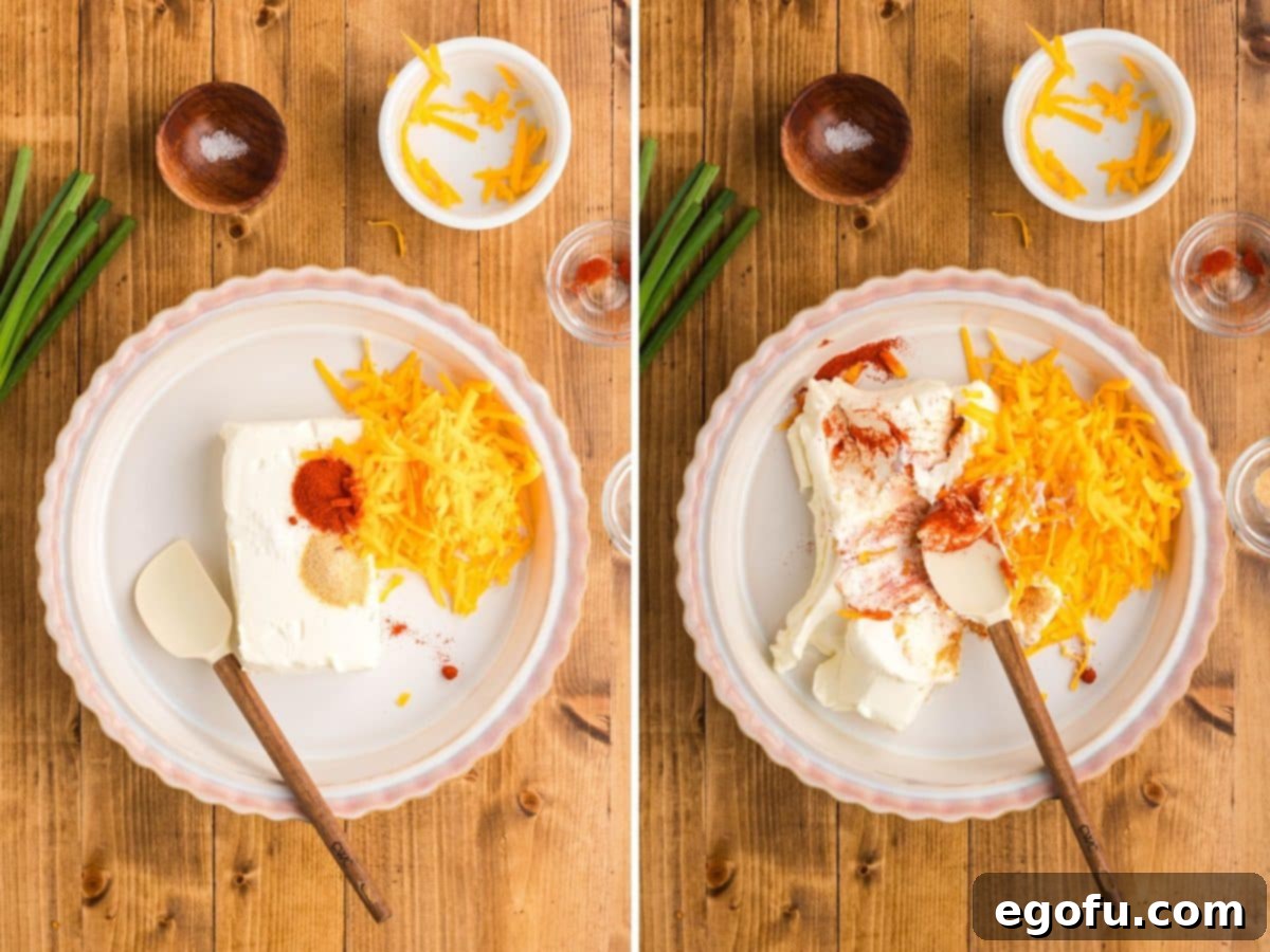 Cream cheese, cheddar cheese, garlic powder, paprika, and salt being vigorously mixed together in an oven-safe pie dish, forming the creamy base.