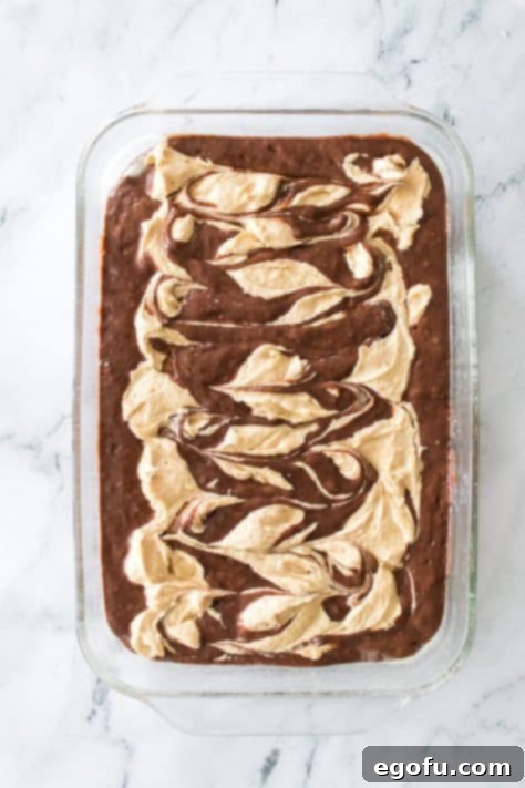 Swirled cream cheese peanut butter mixture in a chocolate cake.