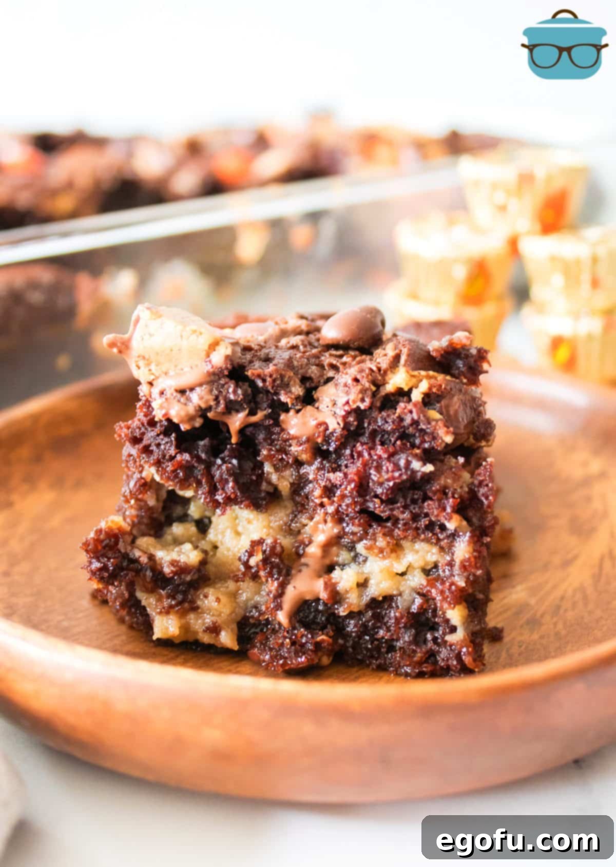 A plate with a large, inviting slice of Peanut Butter Earthquake Cake, possibly with a scoop of ice cream.
