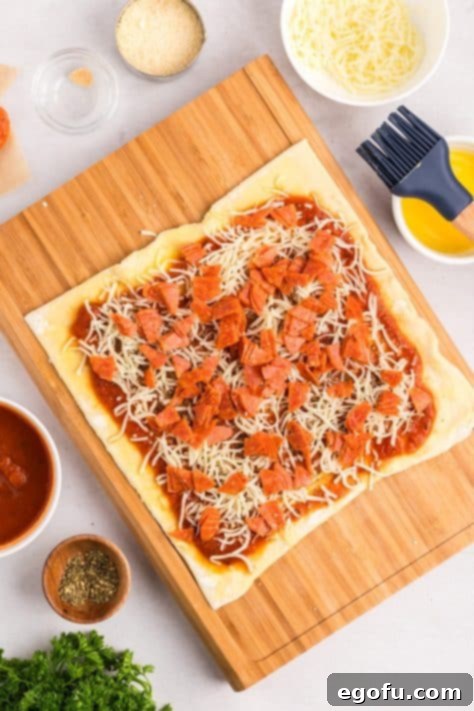 Puff pastry layered with sauce, cheese, pepperoni, and seasonings.