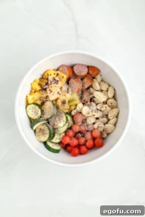 One-Pan Sausage and Gnocchi Bake 11 A bowl of veggies, sausage, and gnocchi with a mix of herbs and seasonings.