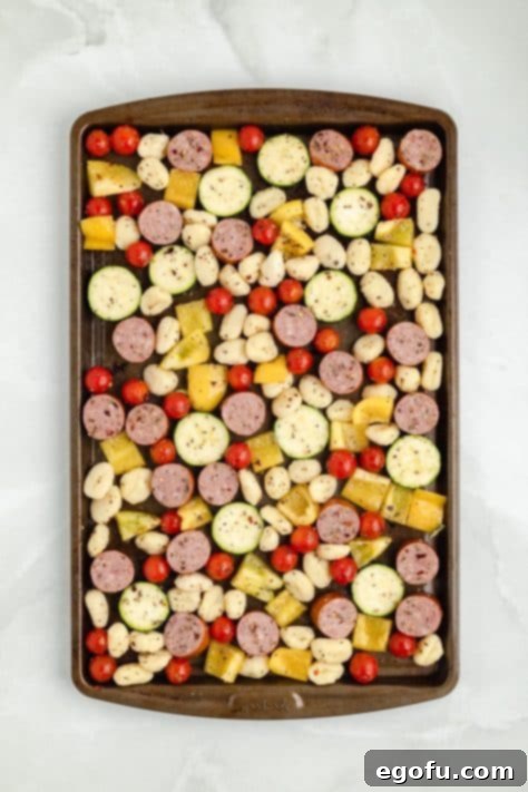 One-Pan Sausage and Gnocchi Bake 12 A sheet pan of coated veggies, sausage, and gnocchi.