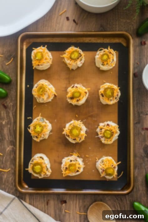 Unbaked pinwheels on a baking sheet.