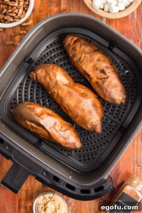 Baked sweet potatoes in an Air Fryer basket.