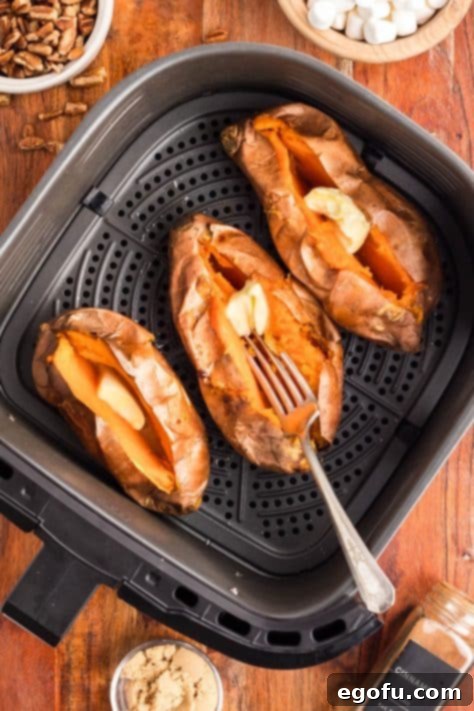 Butter being added to sweet potatoes.
