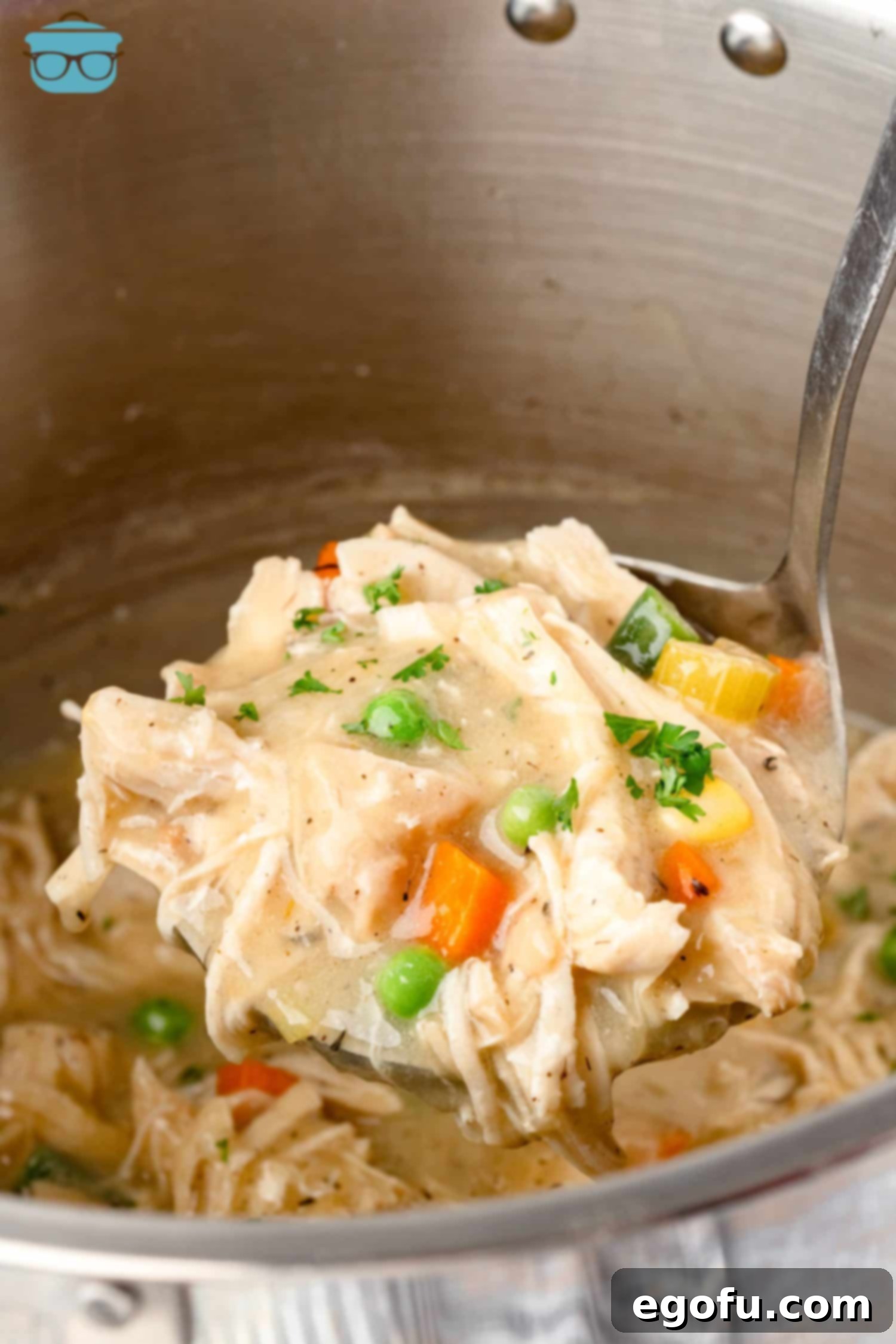 A scoop of creamy Instant Pot Chicken Pot Pie served in a bowl, highlighting the rich filling and tender pieces.