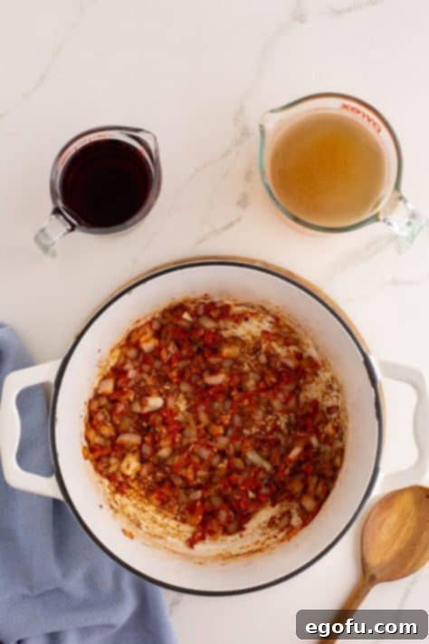 Onions, tomato paste, garlic, and flour in a pot.