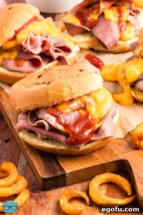 An overflowing Arby's Roast Beef and Cheddar Cheese Sandwich.