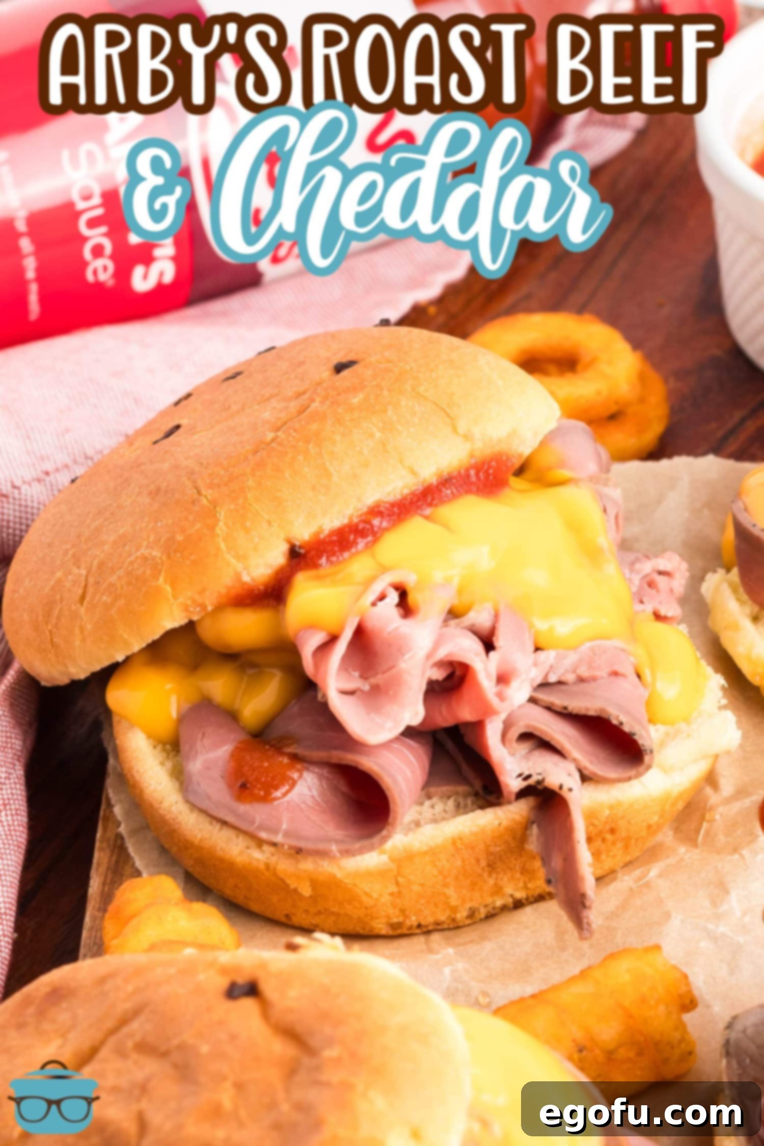 An open Arby's Roast Beef and Cheddar on a board. 